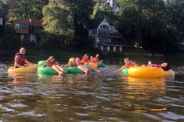 a group of people on a raft in a pool of water