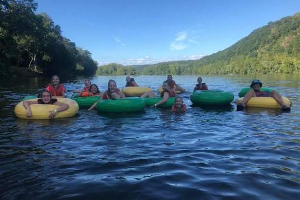 a group of people in a small boat in a body of water