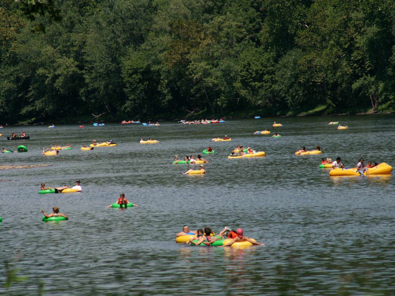 a group of people rowing a boat in a body of water