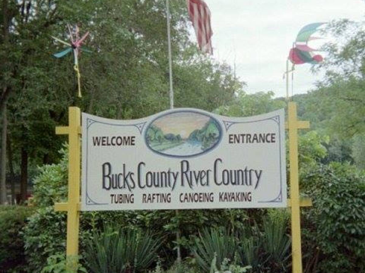 a sign in front of a tree