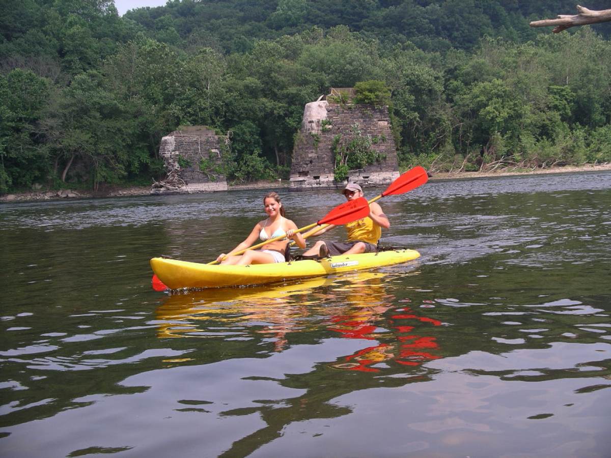a group of people rowing a boat in the water