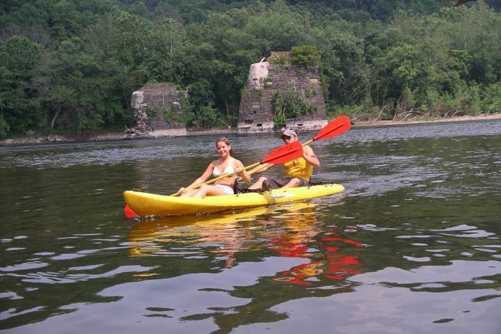 a group of people rowing a boat in the water