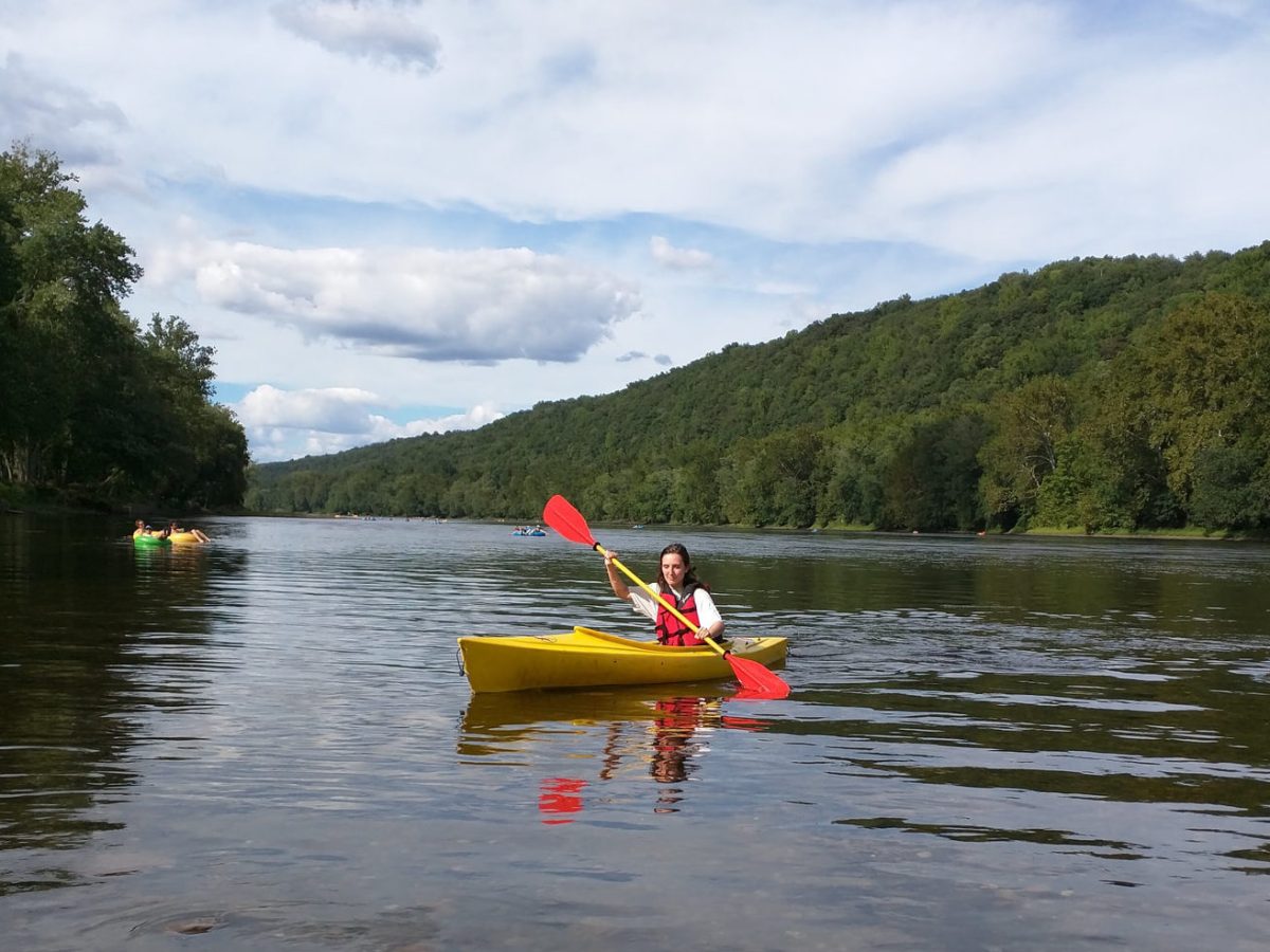 a group of people rowing a boat floating on a body of water