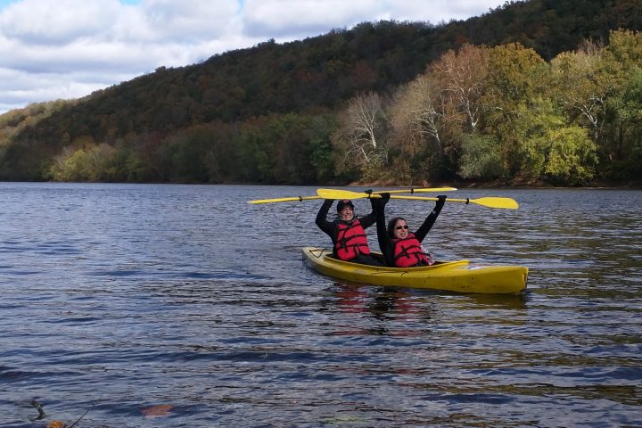 a man riding on the back of a boat in a body of water