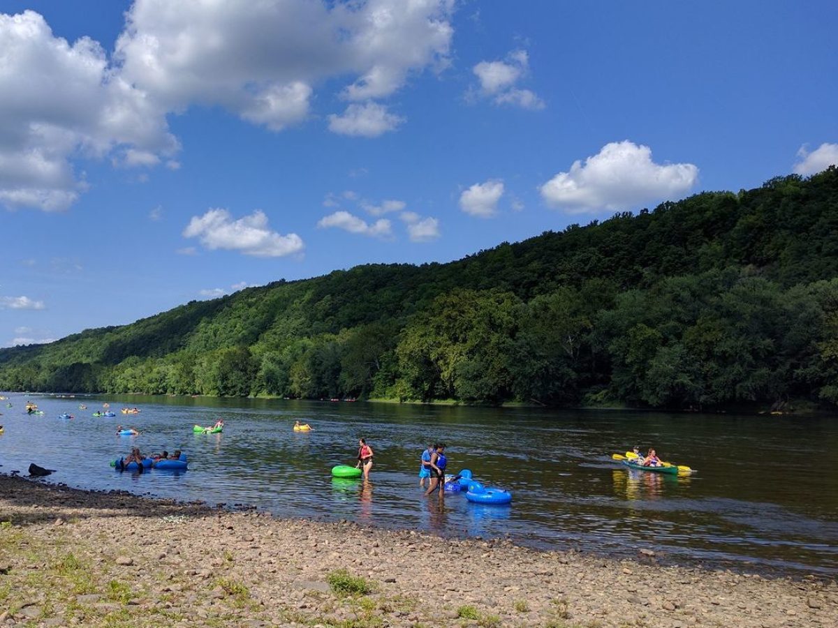 a group of people on a beach near a body of water
