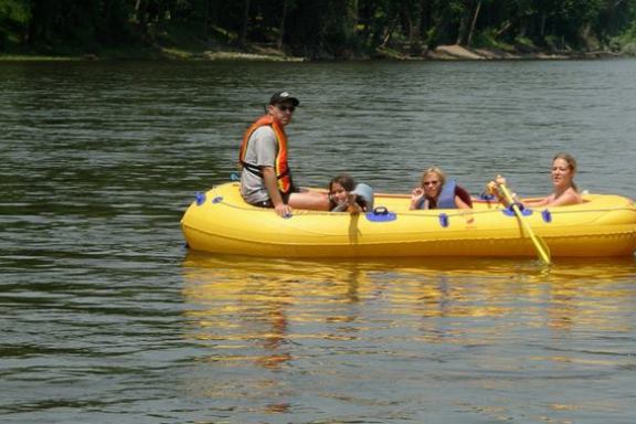 a group of people in a small boat in a body of water