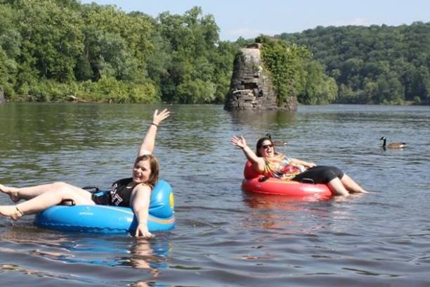 a group of people rowing a boat in the water