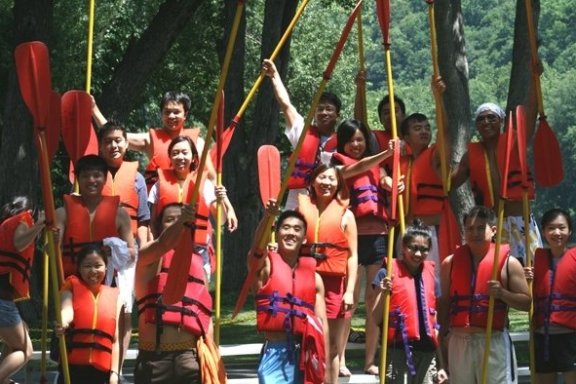 a group of people standing in front of a crowd posing for the camera