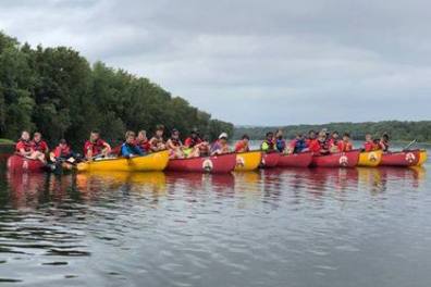 a group of people in a small boat in a body of water