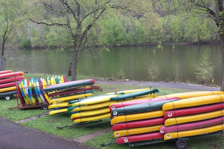 a group of lawn chairs sitting on top of a body of water