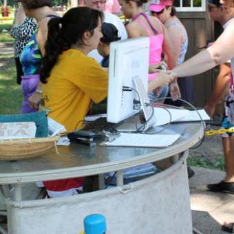 a group of people standing around a table
