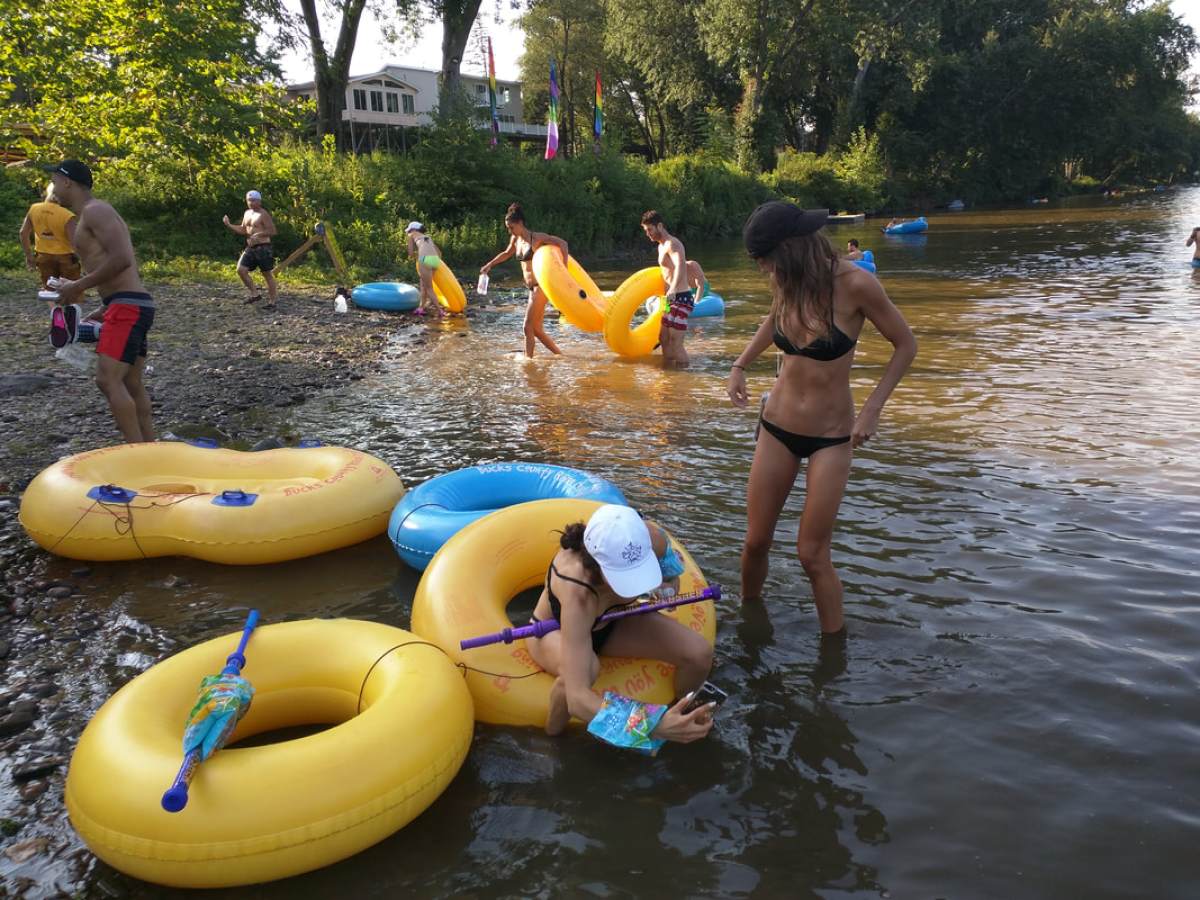 a group of people playing frisbee in a pool of water