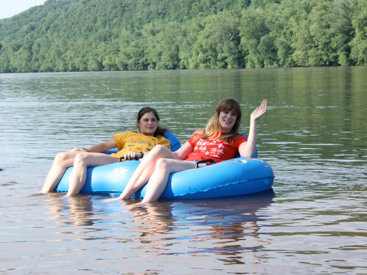 a person sitting next to a body of water