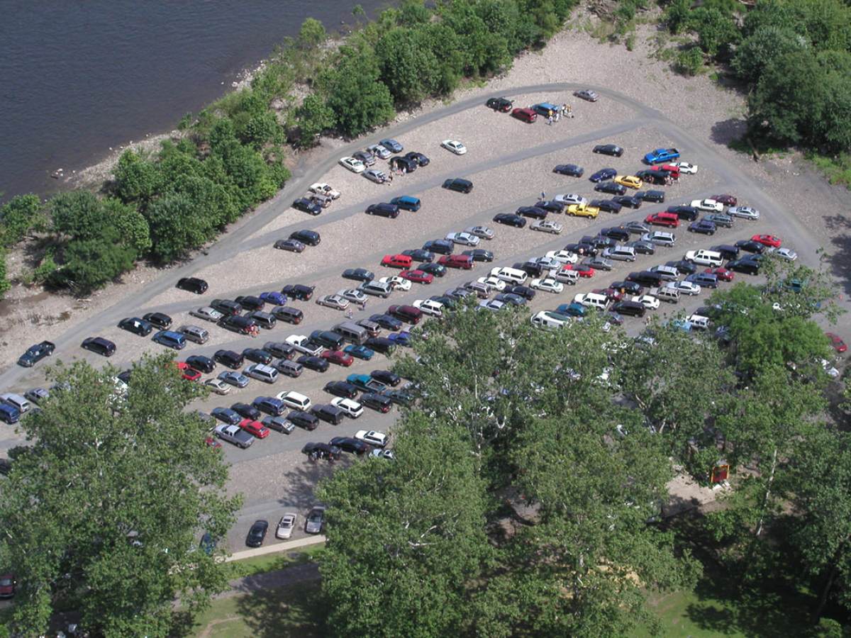 a group of people standing in a parking lot