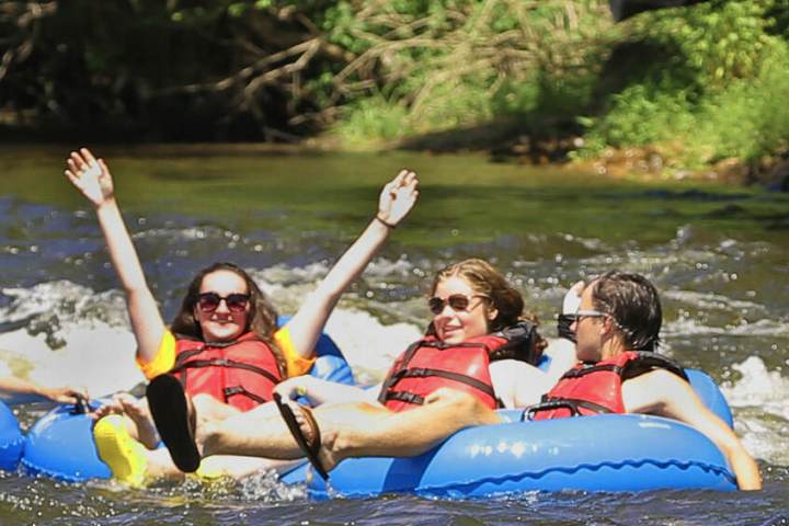 a group of people riding on a raft in a body of water