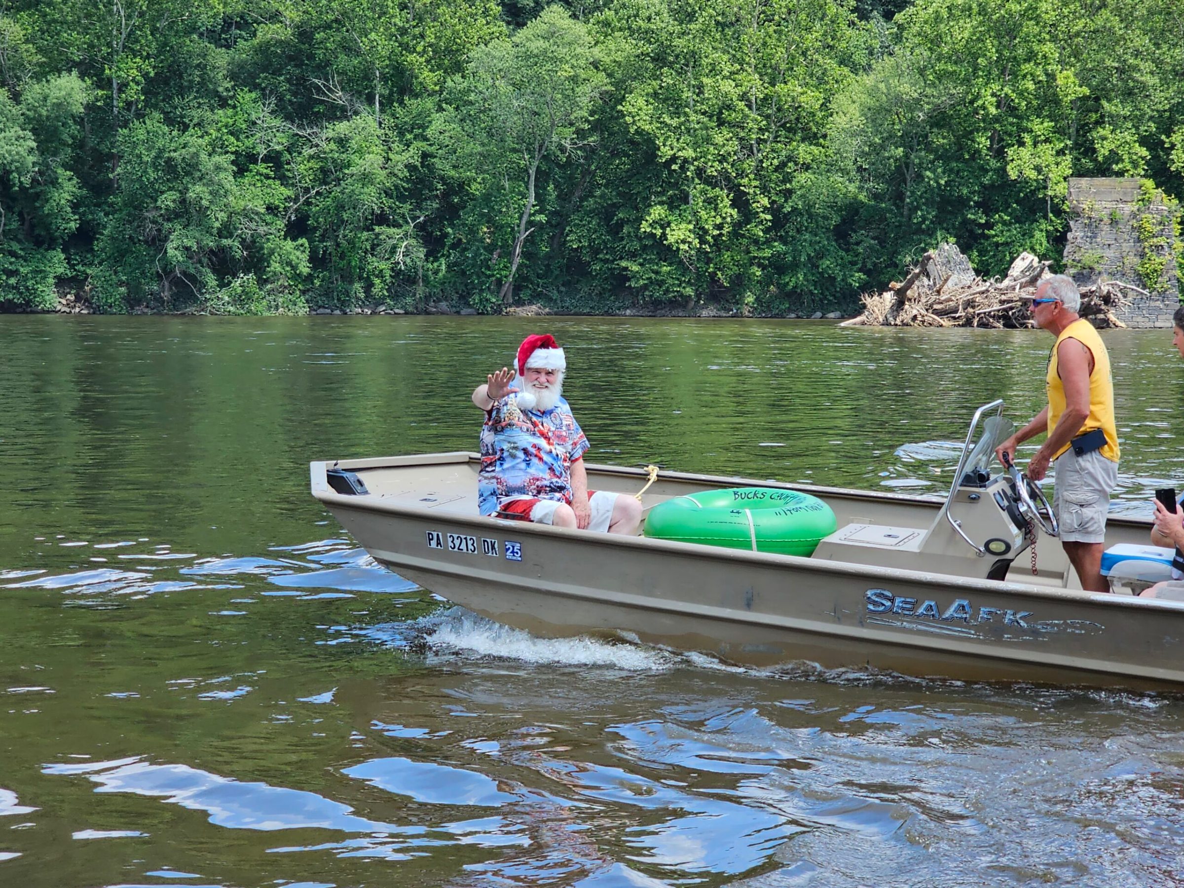 a group of people riding on the back of a boat in the water