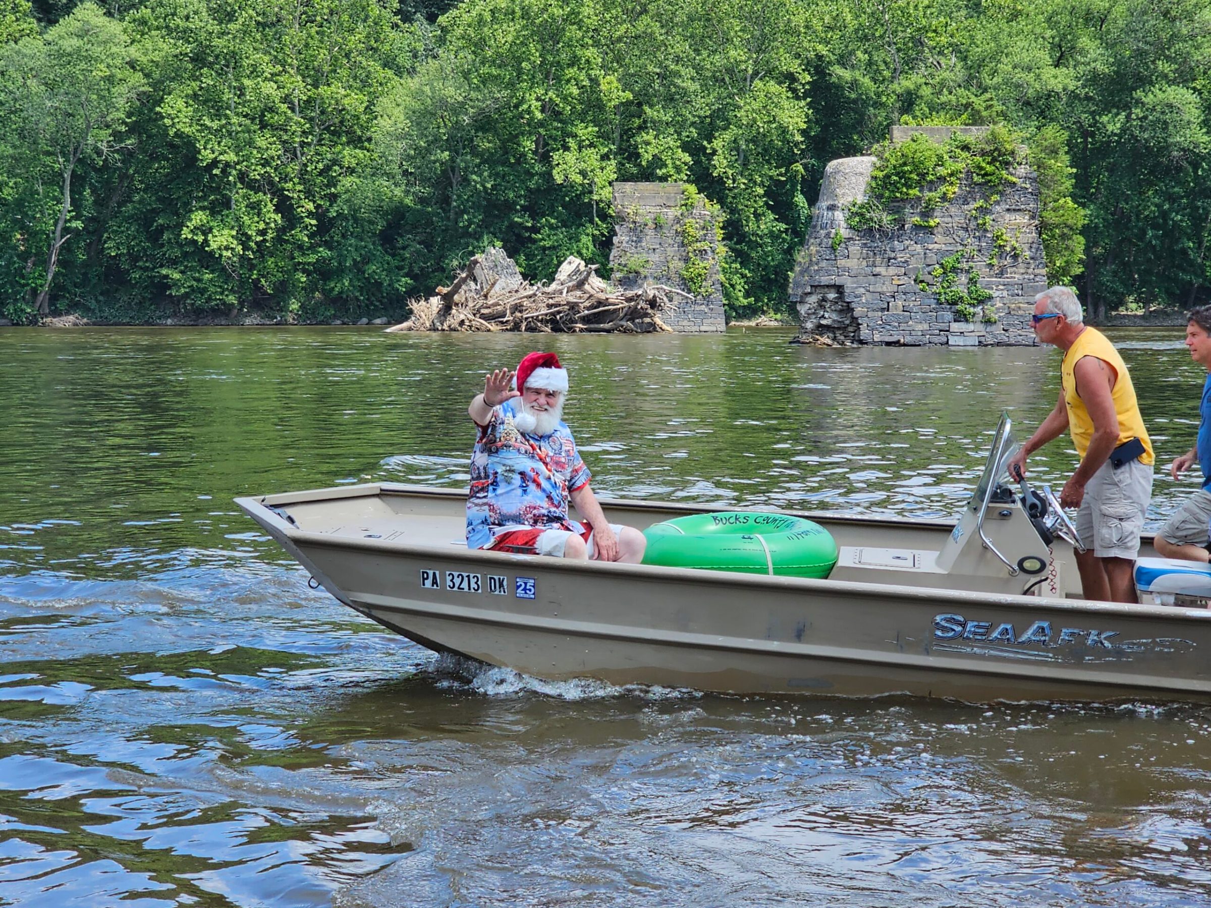 a group of people riding on the back of a boat in the water