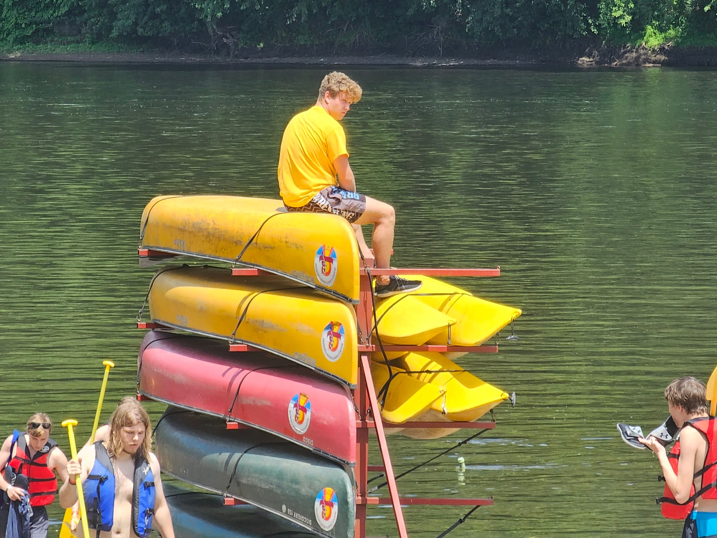 a man riding on the back of a boat in the water
