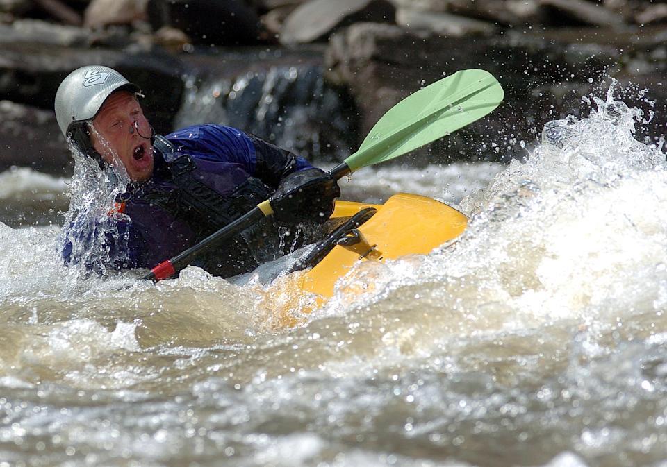 Person kayaking in yellow kayak